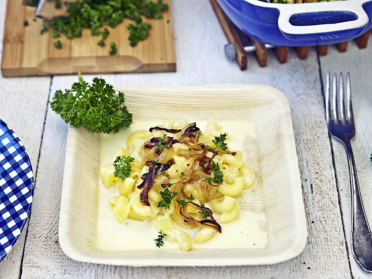 Ein Holzschälchen mit dem Rezept auf einem hellen, weißen Holztisch.