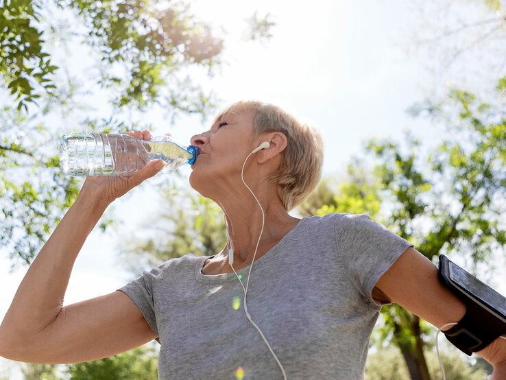 Frau trinkt aus Wasserflasche beim Sport | © iStock/Nastasic