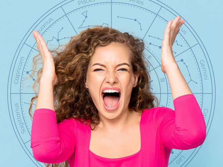 Eine Frau mit lockigem Haar trägt ein pinkes Oberteil und schreit frustriert. Im Hintergrund ist ein astrologisches Rad mit den Symbolen der Sternzeichen zu sehen.