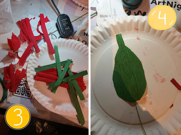 Grünes und rotes Krepppapier in Streifen auf einem weißen Pappteller verteilt, daneben Bastelutensilien wie Kleber und eine halbfertige Blüte. | © Linda Pötzsch